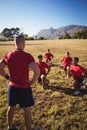 Trainer instructing kids while exercising in the boot camp Royalty Free Stock Photo