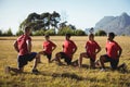 Trainer instructing kids while exercising in the boot camp