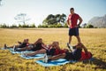 Trainer instructing kids while exercising in the boot camp Royalty Free Stock Photo