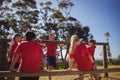 Trainer instructing kids during obstacle course training