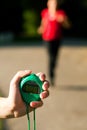 Trainer measuring time of runner Royalty Free Stock Photo