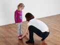 Trainer showing leg position to a little girl