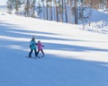 A trainer teaches a child to ski