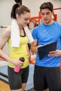Trainer and woman discussing workout plan Royalty Free Stock Photo