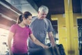 Trainer working exercise with senior man in the gym. Ma Royalty Free Stock Photo