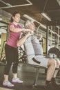 Trainer working exercise with senior man in the gym. Ma Royalty Free Stock Photo