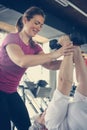 Trainer working exercise with senior woman in the gym. Royalty Free Stock Photo