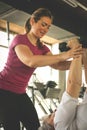 Trainer working exercise with senior woman in the gym. Royalty Free Stock Photo