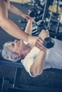 Trainer working exercise with senior woman in the gym. Royalty Free Stock Photo