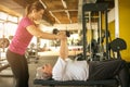 Trainer working exercise with senior woman in the gym. Royalty Free Stock Photo