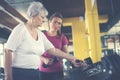 Trainer working exercise with senior woman in the gym. Royalty Free Stock Photo