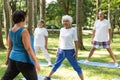 Trainer working out with seniors outdoor