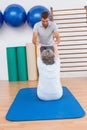 Trainer working with senior woman on exercise mat Royalty Free Stock Photo