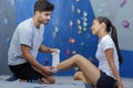 Trainer wrapping bandage on female wall climber Royalty Free Stock Photo