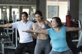 Trainer young female training yoga teach in seniors sports class Royalty Free Stock Photo