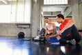 Trainers are teaching to push. Male personal trainer teaching to female in a hard suspension training. Plank exercise Royalty Free Stock Photo