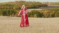 Training in the autumn field - a belligerent woman wields with a sword