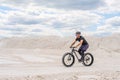 Training a bicyclist in a chalky quarry. A brutal man on a fat bike.