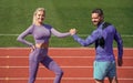 training with coach. fitness partners. athletic man and woman compete in armwrestling. male and female coach on stadium Royalty Free Stock Photo