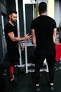 Training coach, personal trainer assisting a client  with gym equipment. Royalty Free Stock Photo