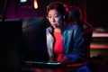Training of esports players in a bootcamp. A young asian gamer at a powerful gaming PC looks at the monitor. Online