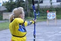 Female archer aiming at a mark on an archery shooting range