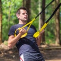 Training with fitness straps outdoors.