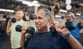 Training, group and senior men exercise together at the gym lifting weights with dumbbells equipment for strength Royalty Free Stock Photo