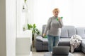 Training At Home. Sporty senior woman doing yoga plank while watching online tutorial on laptop, exercising in living Royalty Free Stock Photo