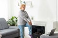 Training At Home. Sporty senior woman doing yoga plank while watching online tutorial on laptop, exercising in living Royalty Free Stock Photo