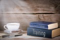 Training and Leadership. Stack of books on wooden desk Royalty Free Stock Photo