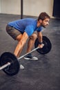 Training like a beast. High angle shot of a handsome young man lifting weights while working out in the gym. Royalty Free Stock Photo