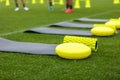 Training mat, goal roller and balance cushion. Sports training equipment on grass field Royalty Free Stock Photo