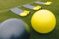 Training mats, foam rollers, cones, trampoline, gym balls and  balance cushions on training grass field. Equipment set for soccer Royalty Free Stock Photo