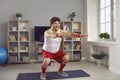 Funny chubby man in retro activewear doing squats during fitness workout at home