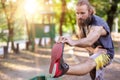 Training outdoors. Young man stretching his legs. Royalty Free Stock Photo