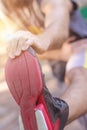 Training outdoors. Young man stretching his legs. Royalty Free Stock Photo