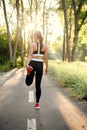 Training in park, woman prepares for running