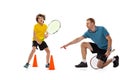 Training. Professional tennis player, coach teaches teen to play tennis isolated over white studio background. Concept Royalty Free Stock Photo