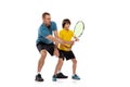 Training. Professional tennis player, coach teaches teen to play tennis isolated over white studio background. Concept Royalty Free Stock Photo