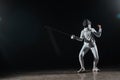 Training with rapier under spotlight on Royalty Free Stock Photo