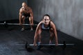 Training to become fighting fit. two people lifting barbells during a gym workout.
