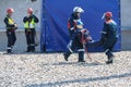 Training to rescue an electrician affected by a high voltage shock. The team takes the person dummy to a safe place for first Royalty Free Stock Photo