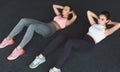 Training together. Fit women doing abs workout on the floor Royalty Free Stock Photo