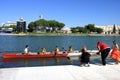 Training of young rowers on the Guadalquivir River in Spain.Launching the boat on the water under the guidance of a coach