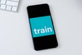 Trainline app logo on a smartphone screen.