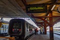 Trains in Gothenburg train stations with people on the platform in the middle