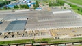 Trains near papermaking plant on sunny day bird eye view