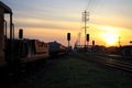 trains on railway tracks by Train Station at sunset Royalty Free Stock Photo