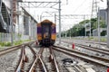 The Trains running on the train tracks to the station in Thailand